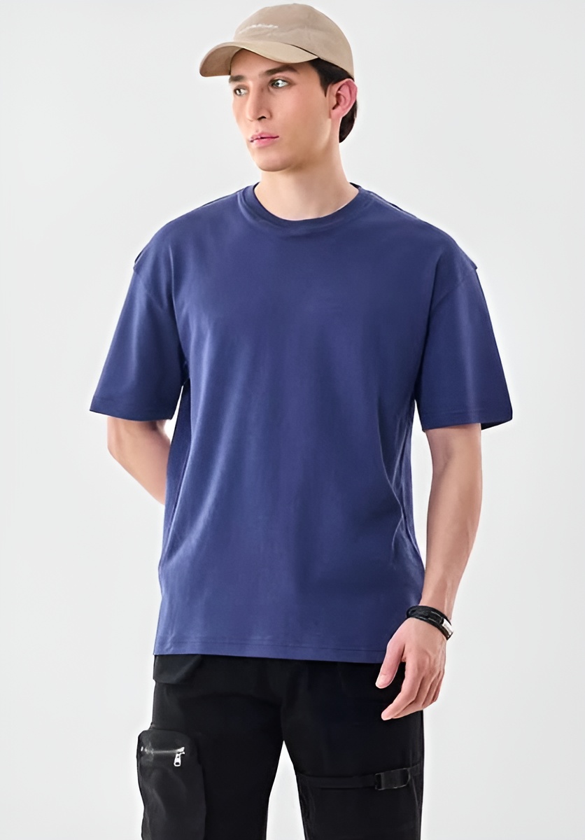 Group of white and grey horses running in field with moody sky background